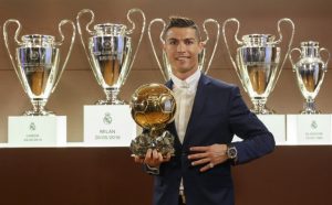 Handout photo released on December 12, 2016 by L'Equipe shows Portugese player Cristiano Ronaldo posing with the Ballon d'Or France Football trophy at the Trophy Room of the Santiago Bernabeu stadium in Madrid. Cristiano Ronaldo was named winner of the Ballon d'Or on December 12, 2016 for the fourth time, organisers France Football said, capping a terrific year for the Real Madrid star. / AFP PHOTO / L'EQUIPE / ANGEL MARTINEZ / RESTRICTED TO EDITORIAL USE - MANDATORY CREDIT "AFP PHOTO / ANGEL MARTINEZ / LEQUIPE" - NO MARKETING NO ADVERTISING CAMPAIGNS - DISTRIBUTED AS A SERVICE TO CLIENTS