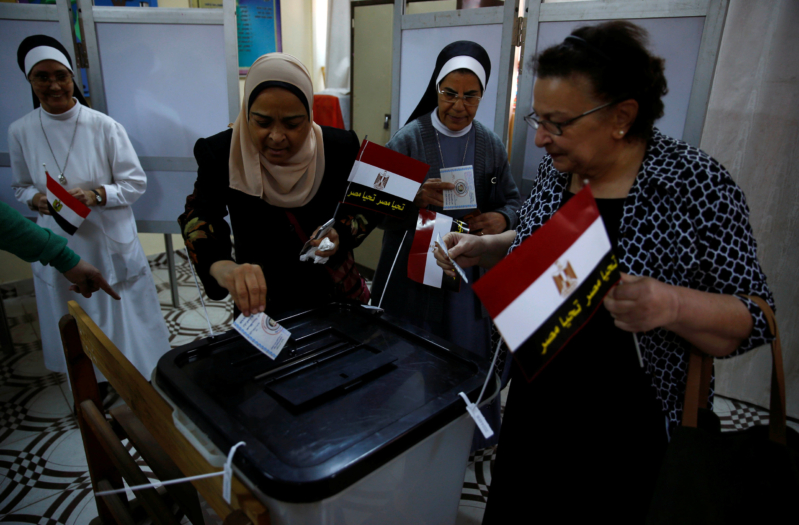 Egyptians cast their votes at a polling station during the presidential election in Cairo